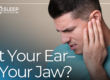 man holding his jaw in pain