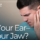 man holding his jaw in pain